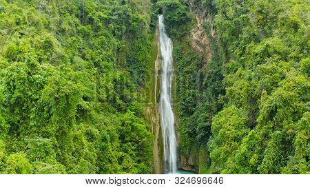 Beautiful Waterfall In Green Forest, Top View. Tropical Mantayupan Falls In Mountain Jungle, Philipp