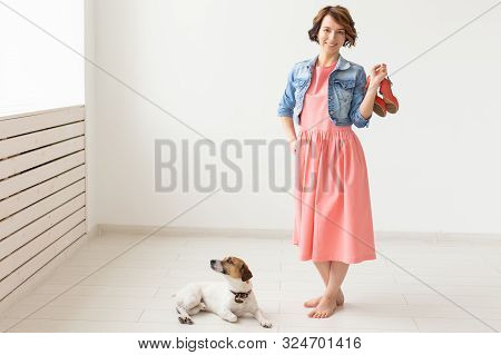 Clothing Designer, People, Pet Concept - Young Woman In Dress And Jeans Jacket With Jack Russell