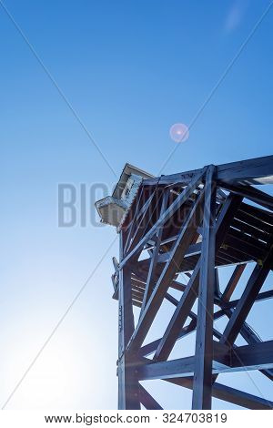 Wooden Observation Tower On A Background Of Blue Sky. Bottom View