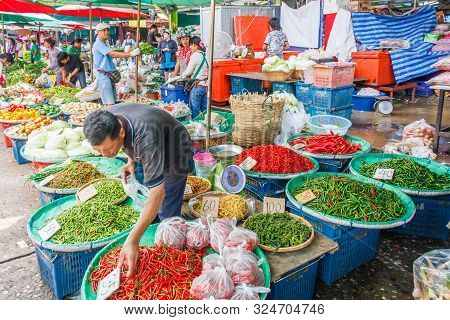 Bangkok, Thailand - January 5th 2010: Man Selling Chillies On Khlong Toei Market. This Is The Larges