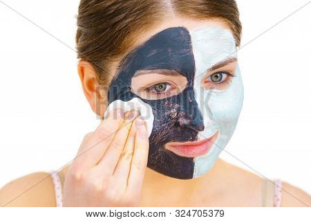 Woman With Clay Carbo Black Mask On One Half Face And White Mud On Second Half. Girl Removing Cosmet