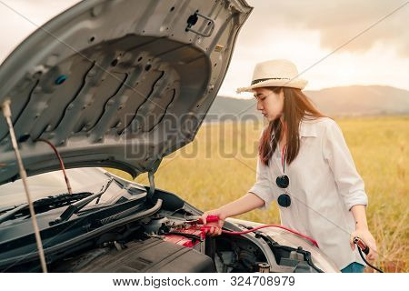 Close Up Woman Connecting Battery Cable Copper Wire For Jumper Repair And Maintenance Electric Of En