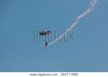 German Skydiver In The Air With A Tail Of Smoke