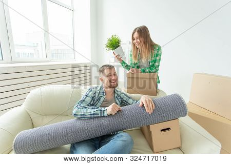 Relocation, Real Estate And Moving Concept - Young Cheerful Couple Moving Into Their New Home