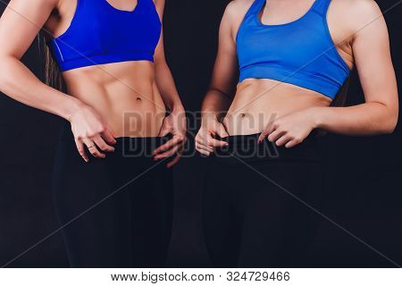 The Belly Of A Slim Woman Close Up. Female Press. A Drop Of Sweat On A Thin Sports Stomach. Training