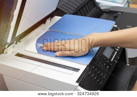 Woman Hands Putting A Sheet Of Paper Into A Copying Device