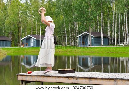 Woman In A Dress With A Tambourine. Shamanistic Dances In Nature. Summer Fun Vacation On The Lake.