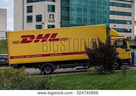 Amsterdam, Schiphol-rijk, The Netherlands, 09/27/2019, A Driving Dhl Truck, Courier Service Delivers