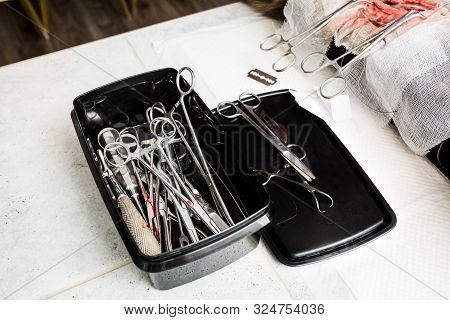Sterile Medical Instruments Of A Surgeon Doctor Folded In A Black Box. Set Of A Veterinarian Surgeon