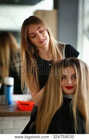 Woman Hairdresser Making Hairstyle For Girl Client. Hairstylist Styling Volume Haircut With Hands. F