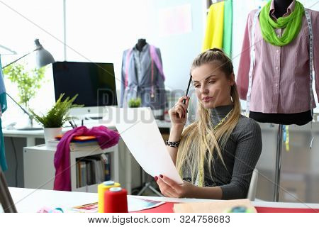 Creating Clothes Design Process And Sewing Concept. Beautiful Sempstress Thinking Working On Dress S
