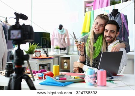 Fashion Industry Blog Content Clothes Creation. Blond Seamstress With Scissors And Handsome Caucasia
