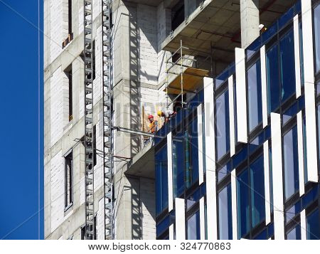 Belgrade, Serbia, September 27, 2019. Construction Worker At Kyscraper Construction Site. Finishing 