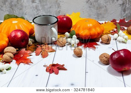 Bright Fall Horizontal Background With Orange Pumpkins And Red Apples, Nuts, Cup Of Tea, Green And Y