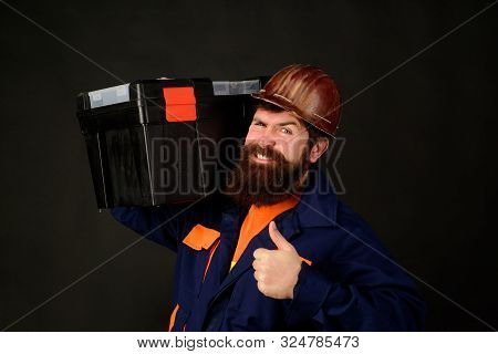 Tools For Repair. Builder Man Carrying Tool Box Giving Thumbs Up. Repairman In Overall Hold Toolbox.