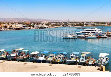 Paphos, Cyprus-july 24, 2019: Fishing Boats And Yachts In Port. View Of The Promenade Of The Resort 