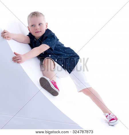 Cute Little Boy Studio Portrait On White Cyclorama. The Concept Of A Happy Childhood. Isolated On Wh