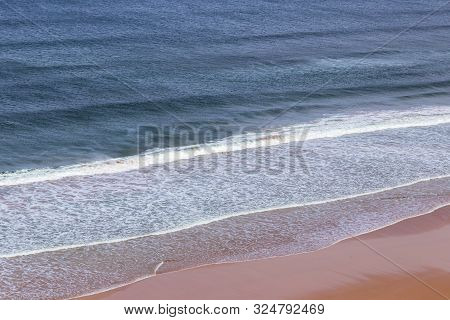 Surfers In The Waves Off Mawgan Porth Beach, North Cornwall, Uk