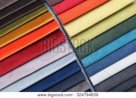Multi-colored Samples Of Upholstery Fabric For Sofas And Chairs Close-up. Selection Of Fabric For In