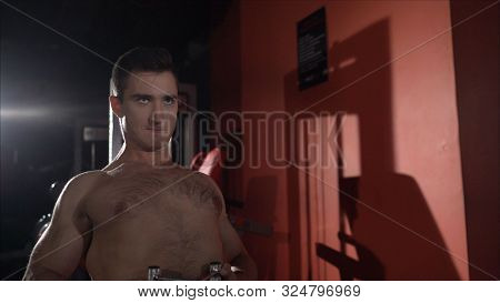 Back Workout In The Gym. Very Power Athletic Guy Bodybuilder, Execute Exercise With Gym Apparatus, O