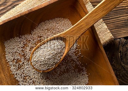 Whole, Organic White Chia Seeds Heap In Woodenl Spoon On Wood Plate And Rustic Table Background Flat