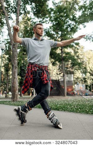 Roller skating, male skater rolling in park