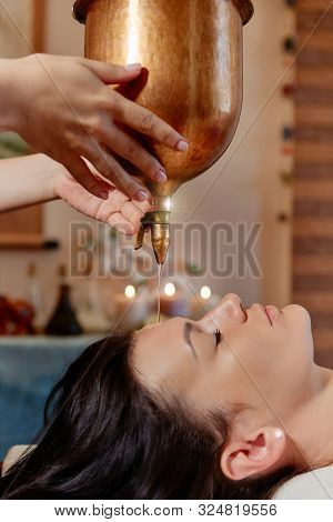 Ayurvedic Shirodhara Procedure. Indian Massage On The Ancient Technique Of Shirodhara. The Best Of I