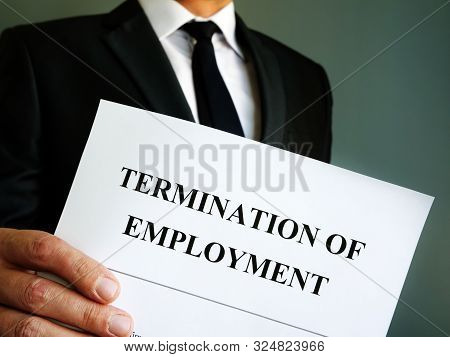 Man Is Holding Termination Of Employment Papers.
