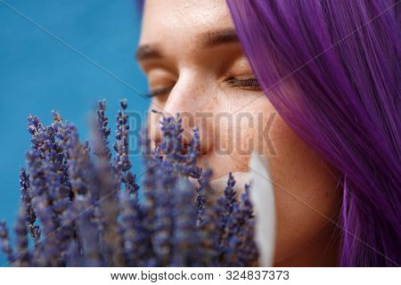 Face Of Young Lady With Purple Hair Eyes Closed And Partly Overshadowed By Lavender Bouquet In Front