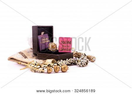 Mom's Anniversary Concept. Golden Ring In A Lather Gift Box With Handmade Pouch And Mom You're Speci