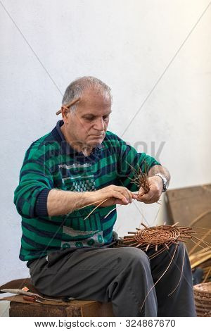 Camacha, Madeira, Portugal - April 19, 2018: A Basket Weaver At Work In The Factory Shop In Camacha 