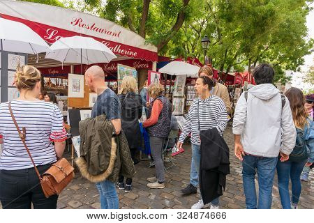 People Strolling The Weekend Markets Of Montmartre, Paris