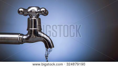Drain water from the Metal tap, Water flowing from modern faucet