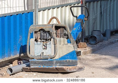 Vibratory Plate Compactor Machine At Street Construction Site