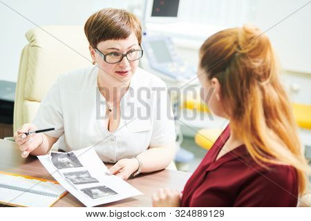 ultrasound scan explanation. Doctor interpreting test results to female patient