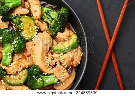 Hunan Chicken In Black Bowl At Dark Slate Background. Hunan Chicken Is Chinese Or Indo-chinese Cuisi