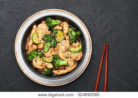 Hunan Chicken In Black Bowl At Dark Slate Background. Hunan Chicken Is Chinese Or Indo-chinese Cuisi