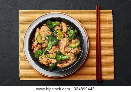 Hunan Chicken In Black Bowl At Dark Slate Background. Hunan Chicken Is Chinese Or Indo-chinese Cuisi