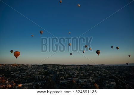 Sunrise Panoramic View To Goreme City And Flying Balloons Over Pigeon Valley Cappadocia, Turkey