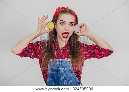 Funny Lovely Girl Is Playing Around, Holding Two Sweet Macaroons Near Ears, Looking Like Cheburashka