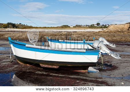 Boats Moored In The Harbor Of Primelin At Low Tide