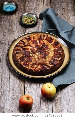 Eplekake. Traditional Norwegian Apple Cake Or Pie Sprinkled Sugar And Cinnamon On Old Rustic Wooden 