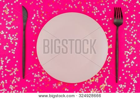 Empty Plate And Modern Cutlery On Pinck Background With Star Sprinkles. Festive Holiday Background. 