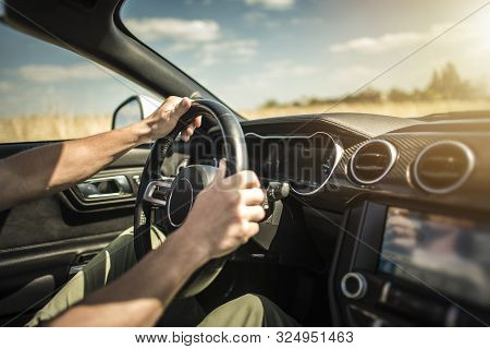 Summer Road Trip Car Drive. Caucasian Driver Behind The Wheel. Automotive Theme.