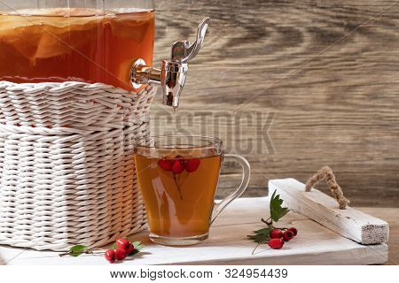 Fresh Homemade Kombucha Fermented Tea Drink In A Jar With Faucet And In A Cup On A White Tray With H