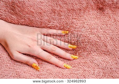Girls Hand With Nailart On Sweater, Close View