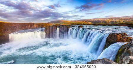 Breathtaking Sunset Landscape Scene Of Powerful Godafoss Waterfall. Dramatic Sky Over Godafoss. Loca