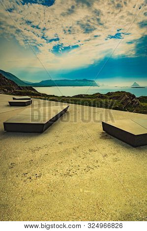 Kleivodden Rest Stop Area Viewpoint With Stone Seating Bench. Arctic Ocean View With Clouds Sky. Att