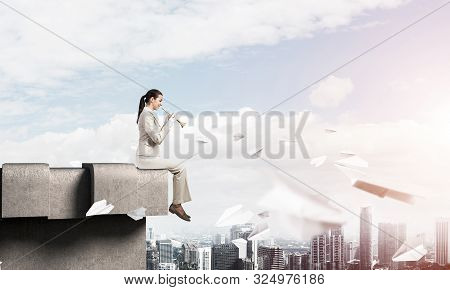 Attractive Young Woman Playing Music On Roof Of Building. Brave Businesswoman With Trumpet Instrumen