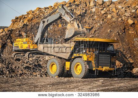 Open Pit Mine Industry, Excavator Loading Coal On Big Yellow Mining Truck For Anthracite
